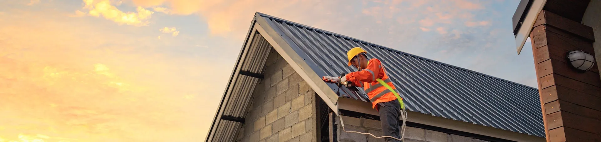 A worker repairing a roof